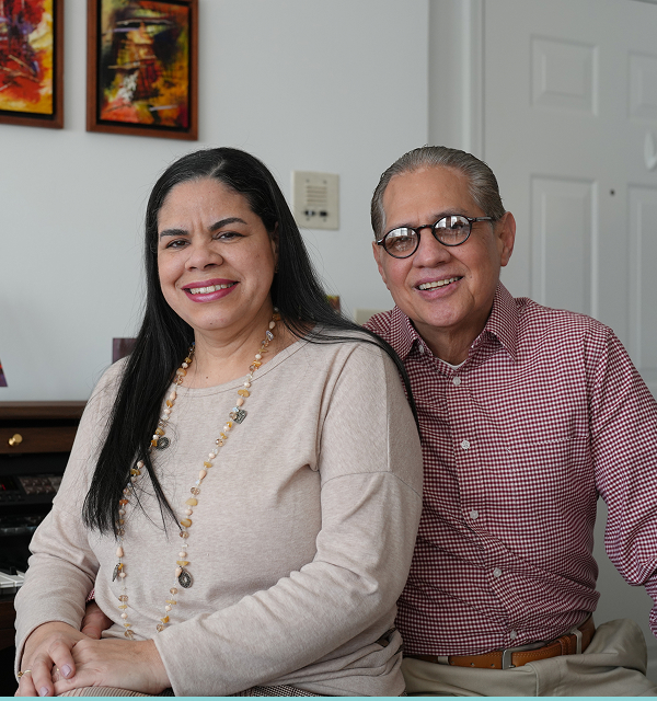 Man and a woman posing for a picture smiling