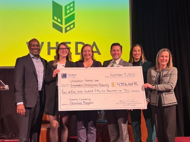 WHEDA holding big check