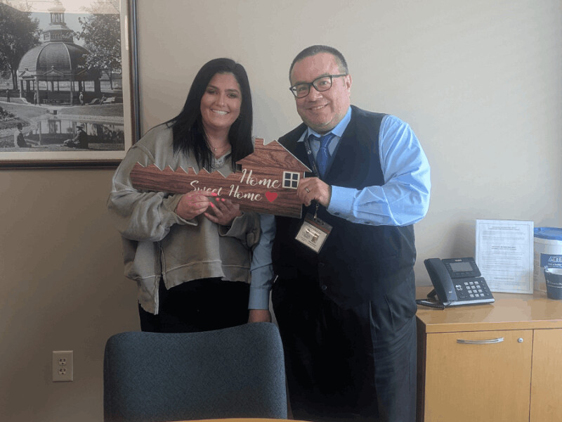 woman and man holding wooden key