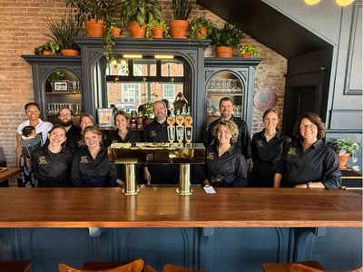 Caption: Staff of Grouchy’s Pub celebrating their opening, including owner Breck Nelson.
