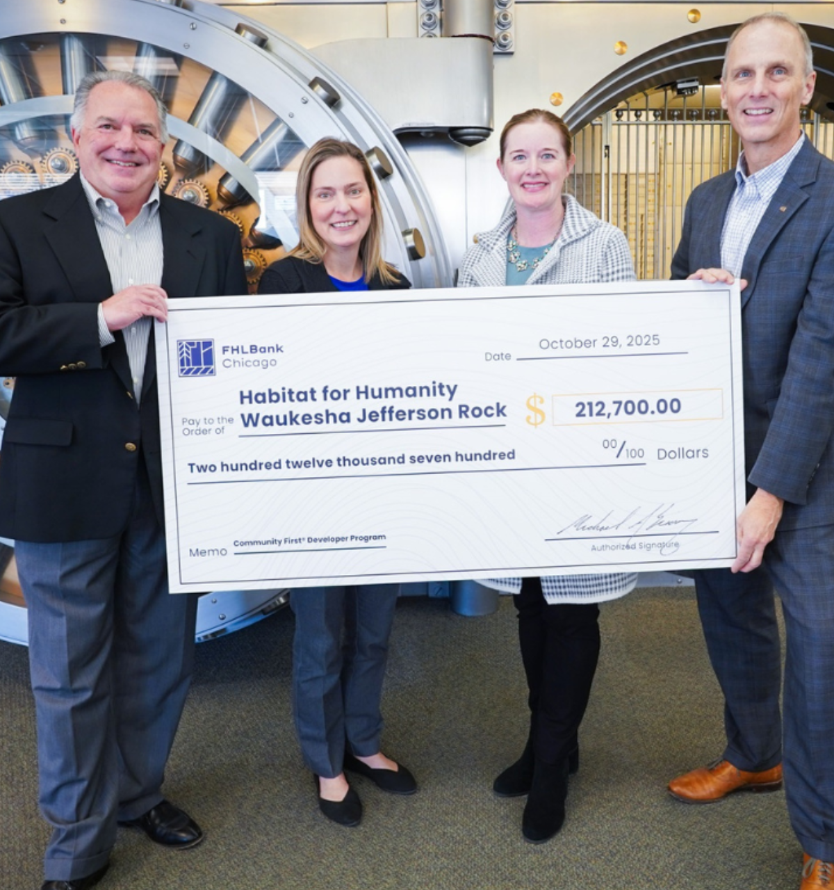 Photo of FHLBank employees and Waukesha Bank employees with giant check